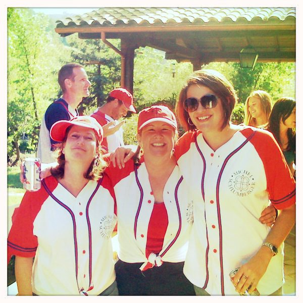 A group of women wearing baseball jerseys.