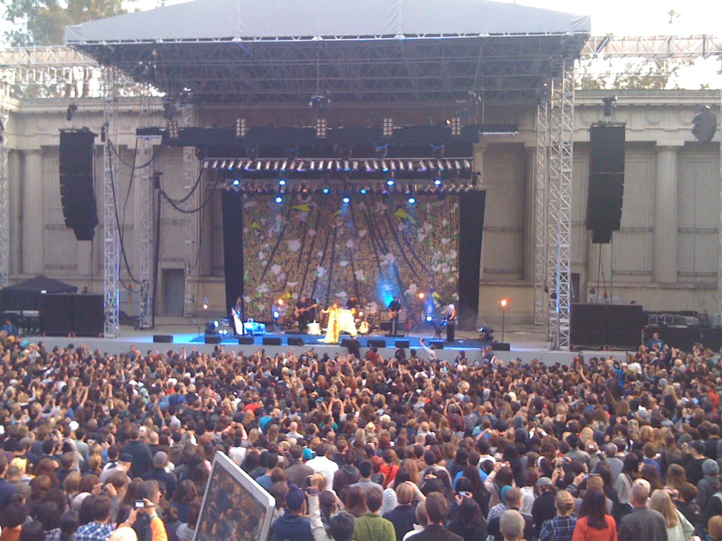 A large crowd of people watching a concert.