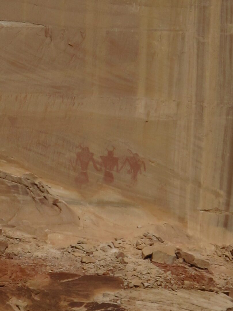 A group of people are standing on a rock in a canyon.