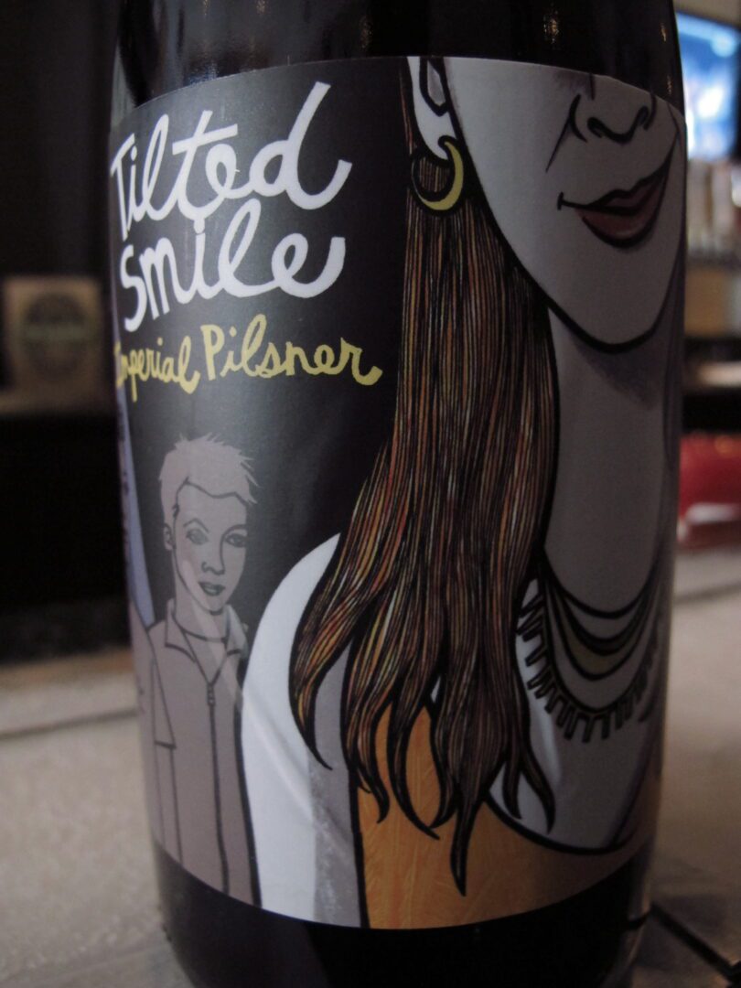 A bottle of beer with a picture of a woman on it.