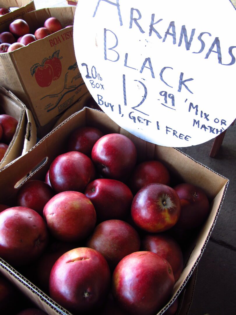 Red apples in a cardboard box.
