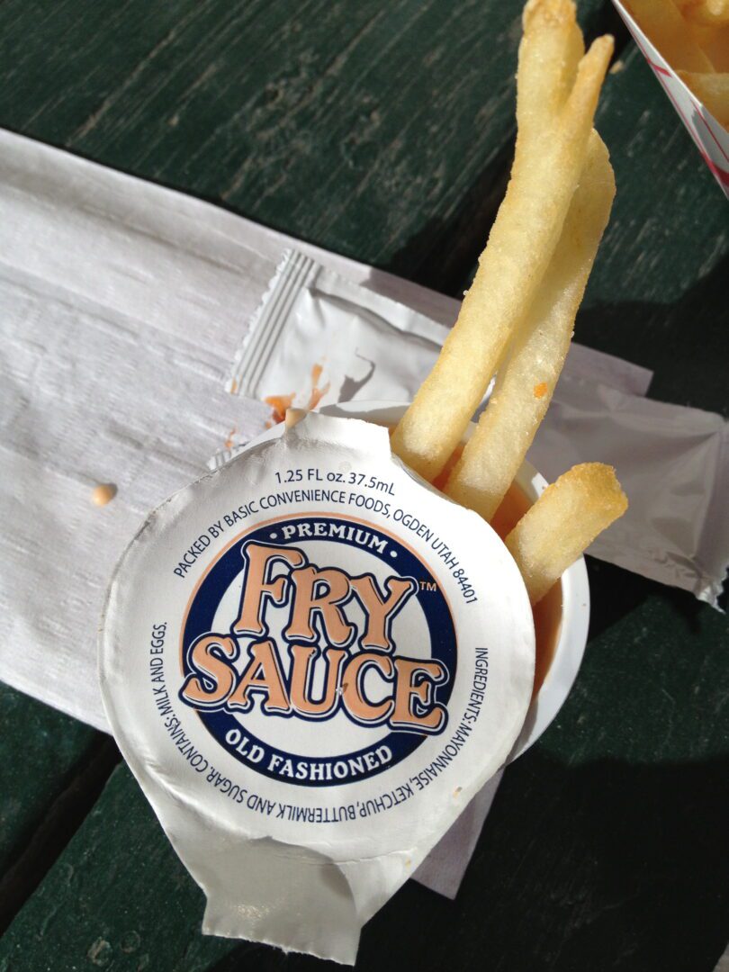 A cup of french fries and a cup of fry sauce.