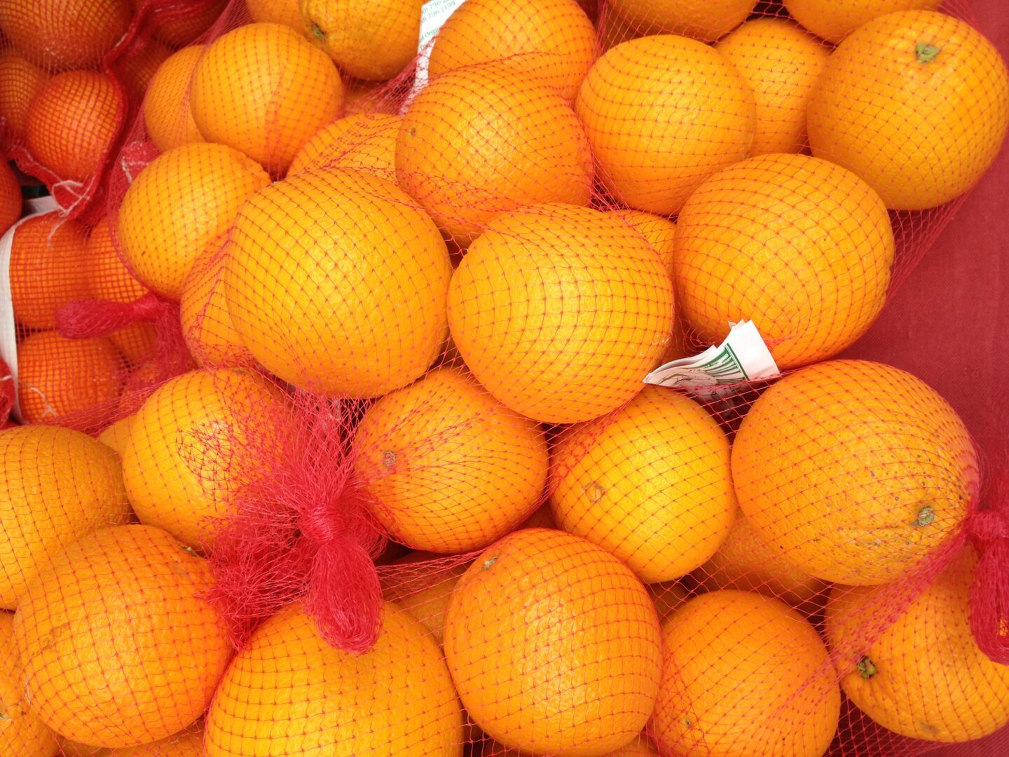 A bunch of oranges in a net.