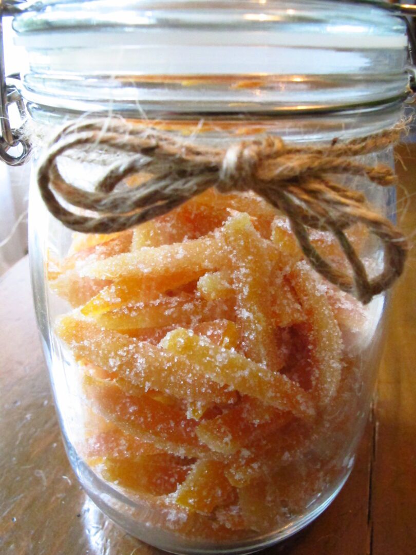 A jar filled with sugared oranges.