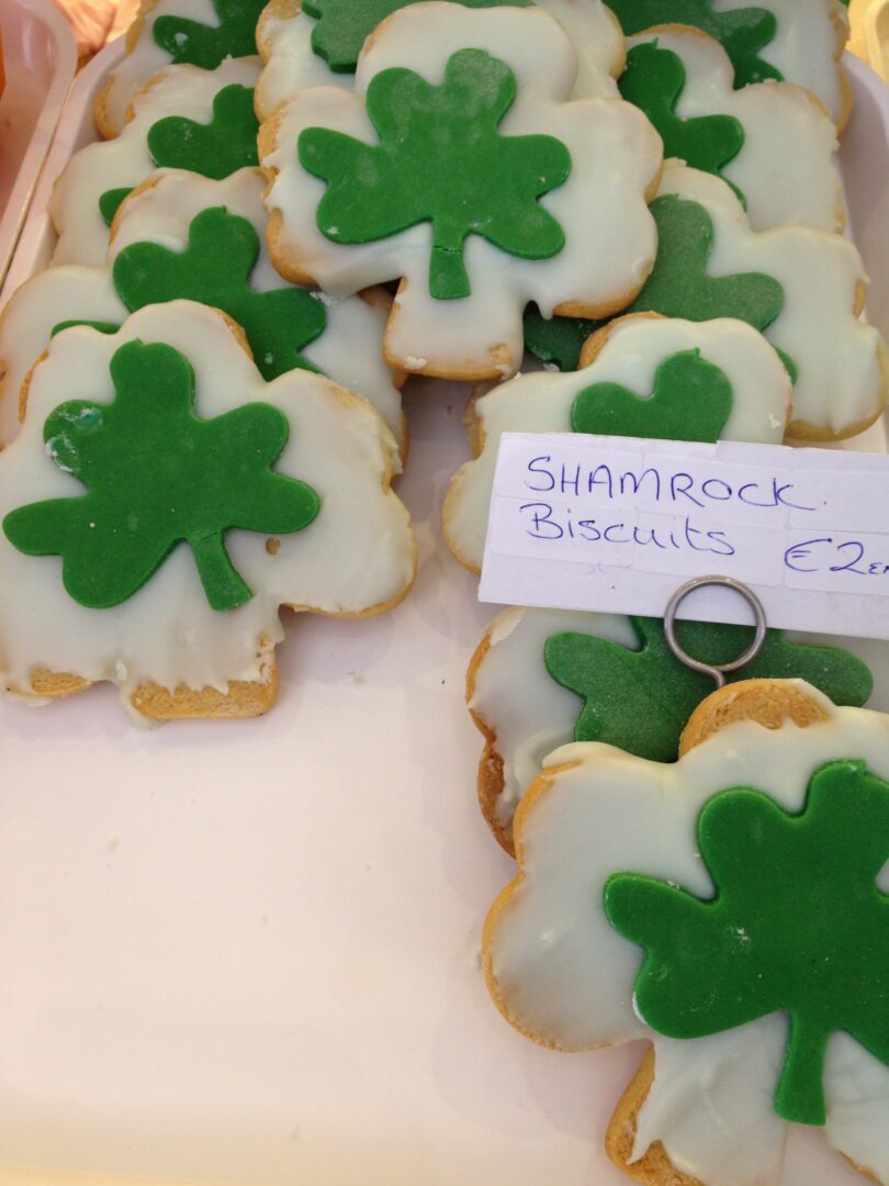 A tray of cookies with shamrocks on them.