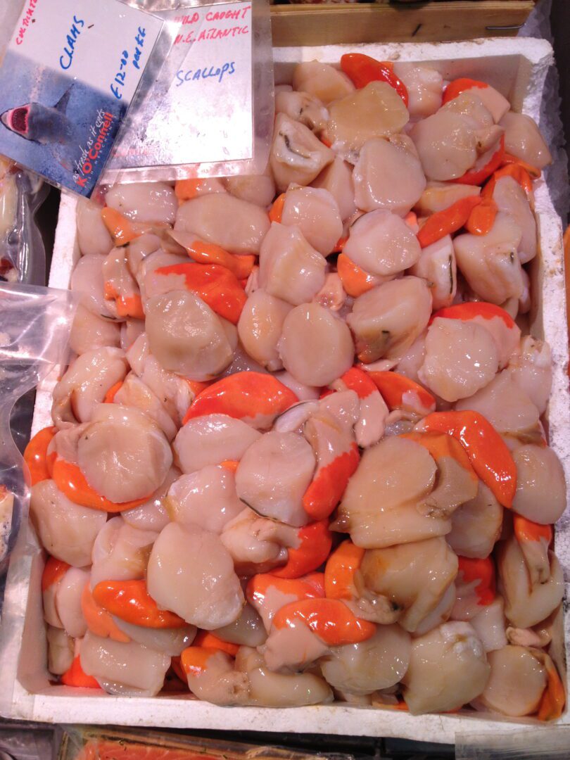 A crate filled with clams and other seafood.