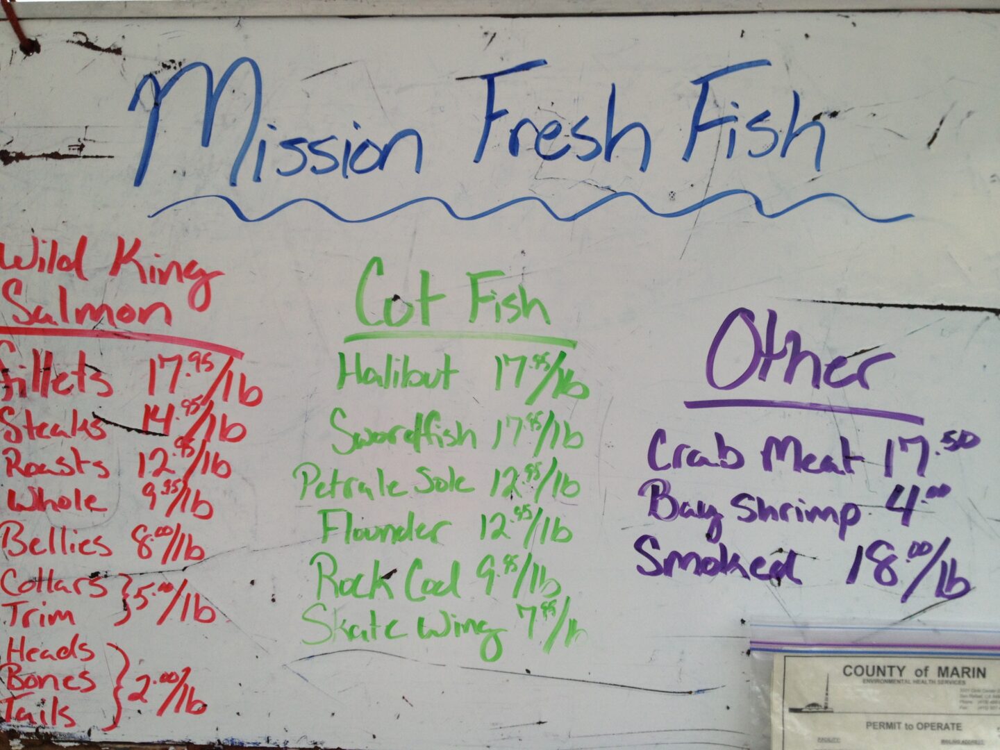 A sign that reads mission fresh fish.