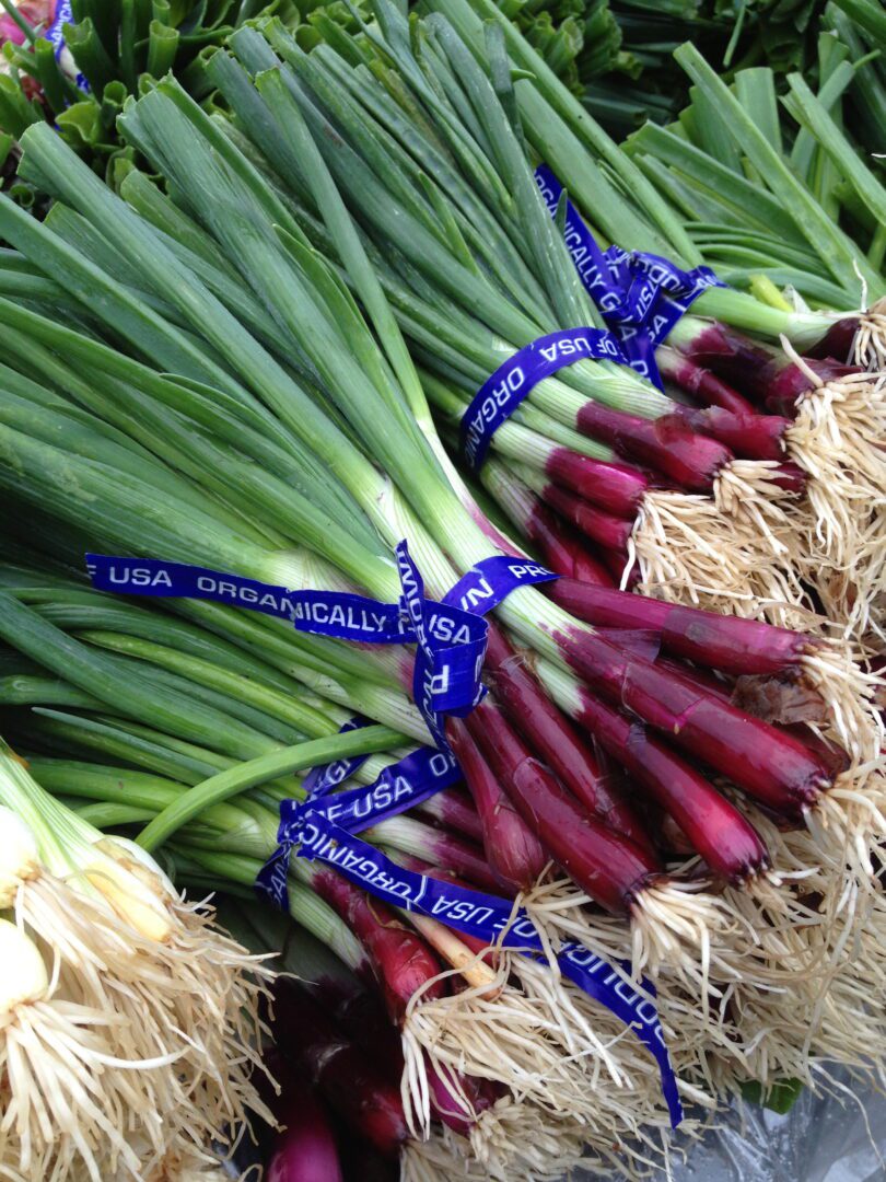 A bunch of onions on a table at a market.