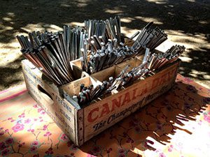 A crate with a lot of spoons on it.