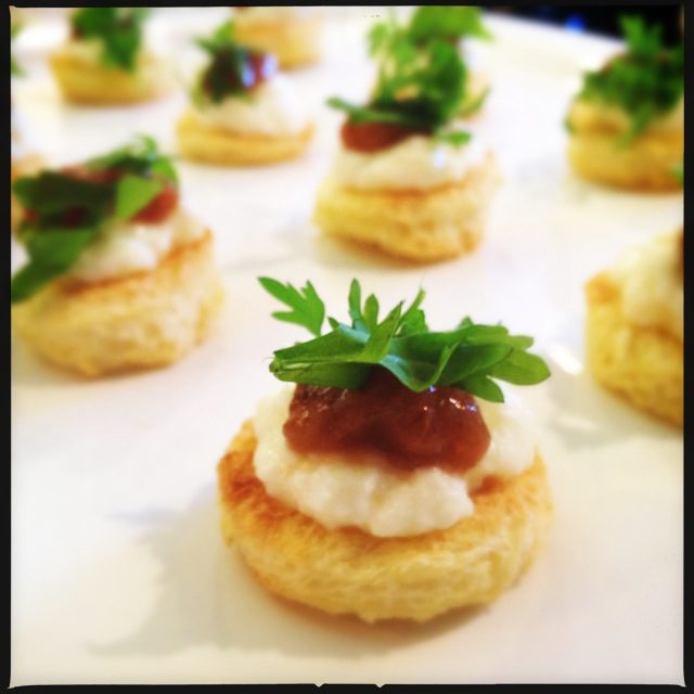 A white plate with small appetizers on it.