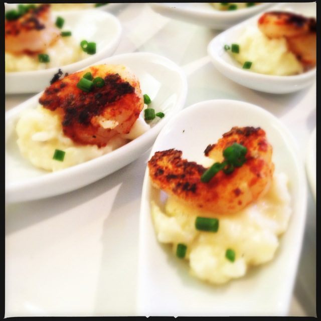 Shrimp appetizers with mashed potatoes and chives.