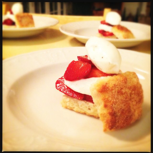 A plate with strawberries and cream on it.