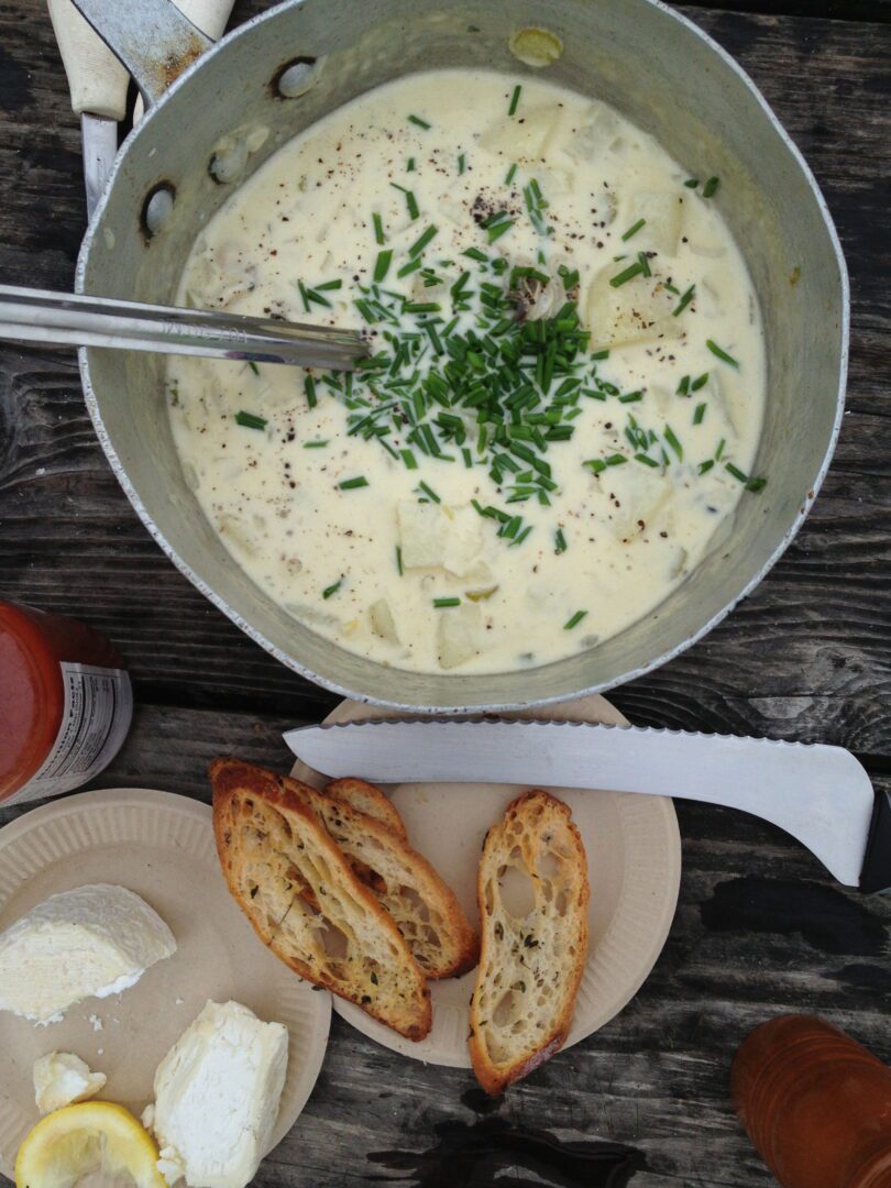 A bowl of soup and bread on a table.