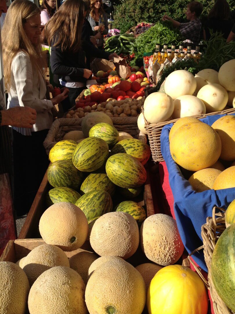 A bunch of melon on a table.