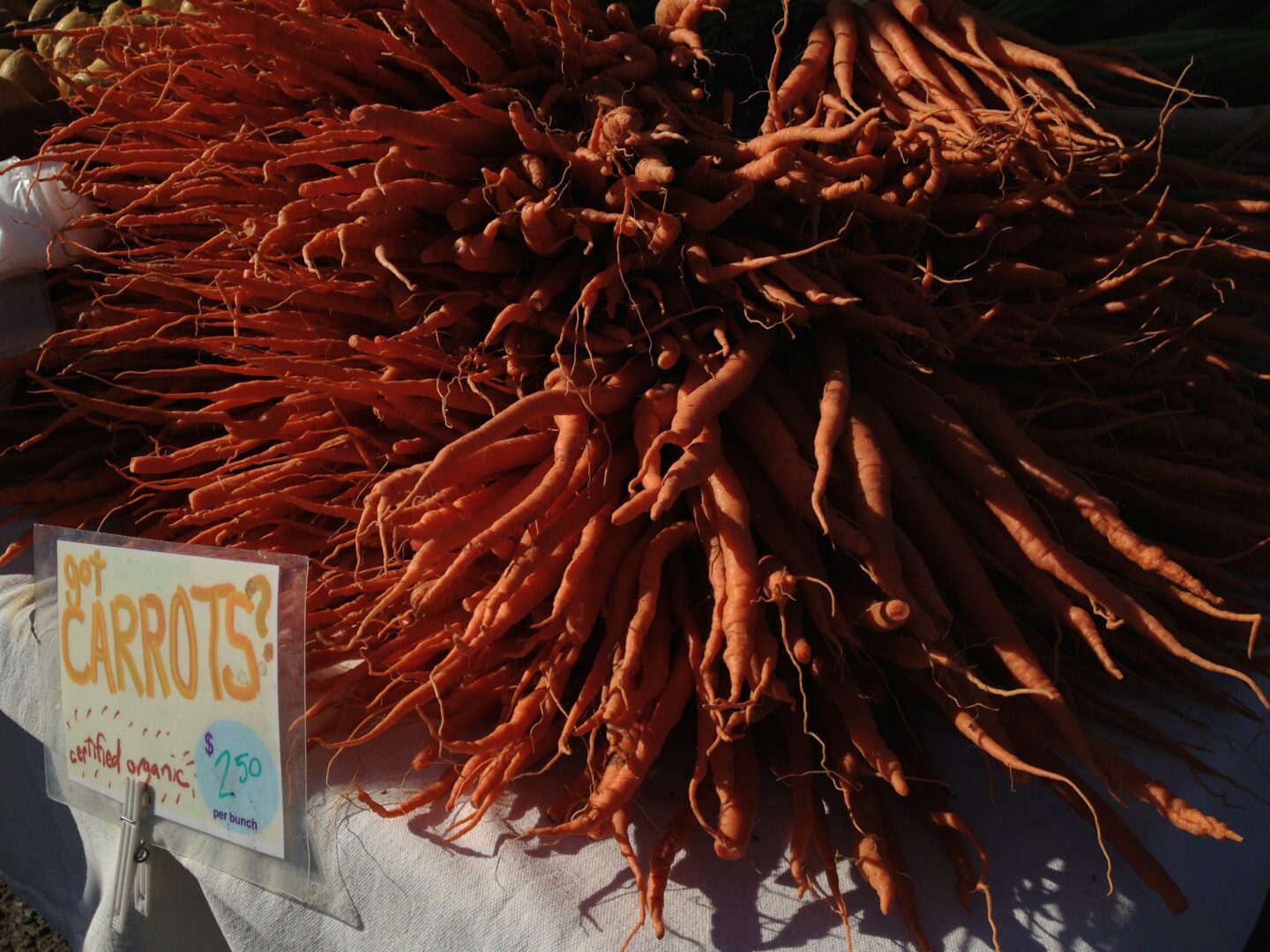 A pile of carrots on a table.