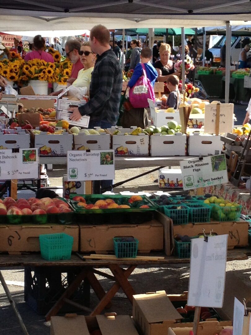 A group of people at an outdoor market.