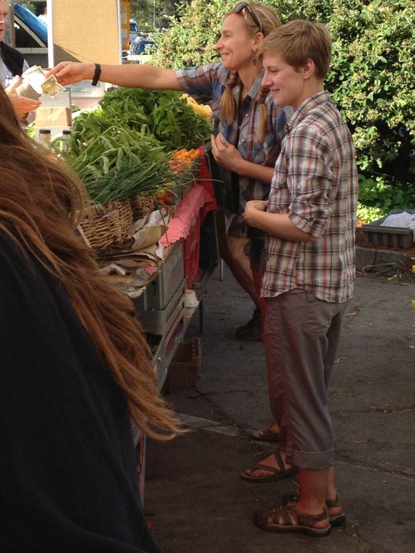 A group of people at a farmer's market.