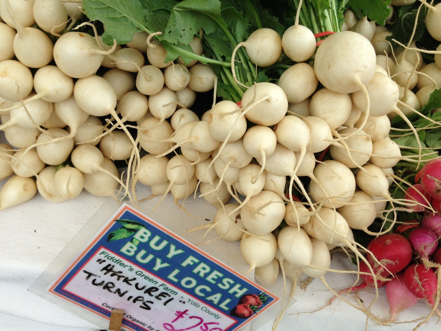 A bunch of radishes on a table.