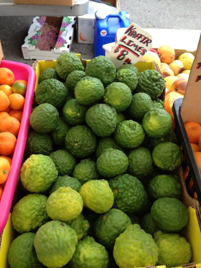 A bunch of oranges and a bunch of limes.