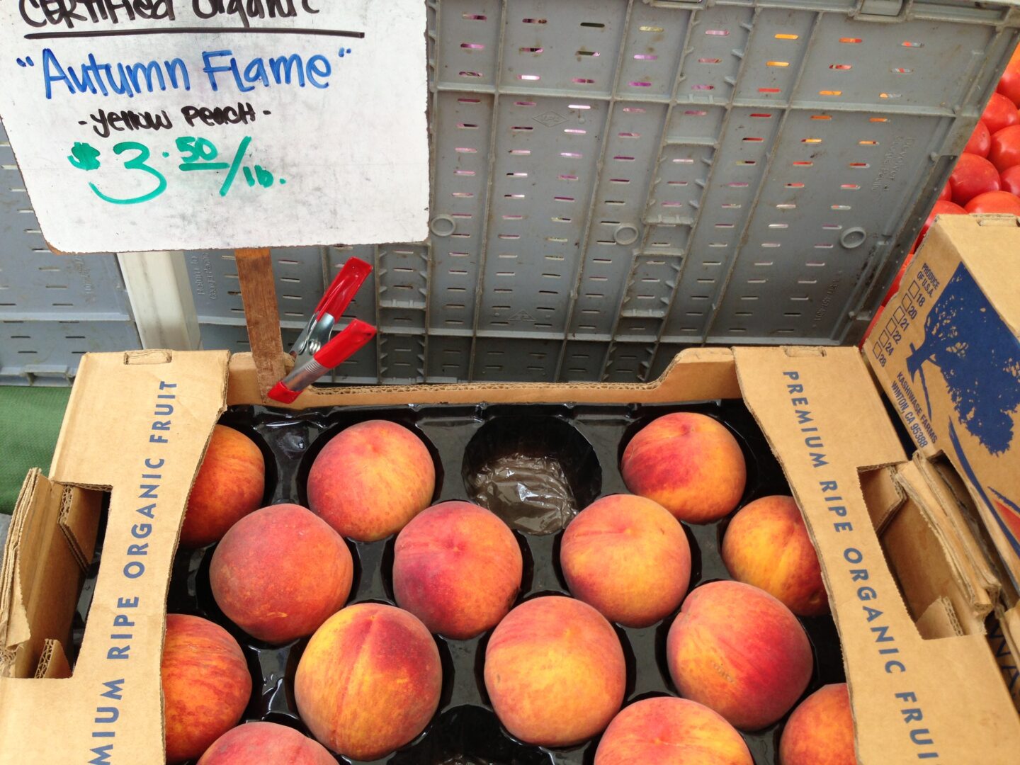 A box of peaches with a sign on it.