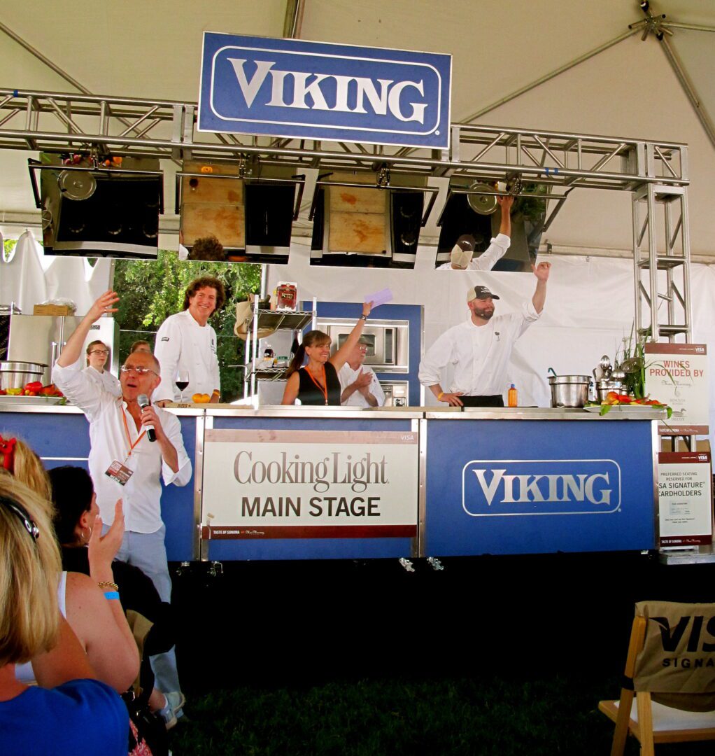 A group of people at a viking cooking light stage.