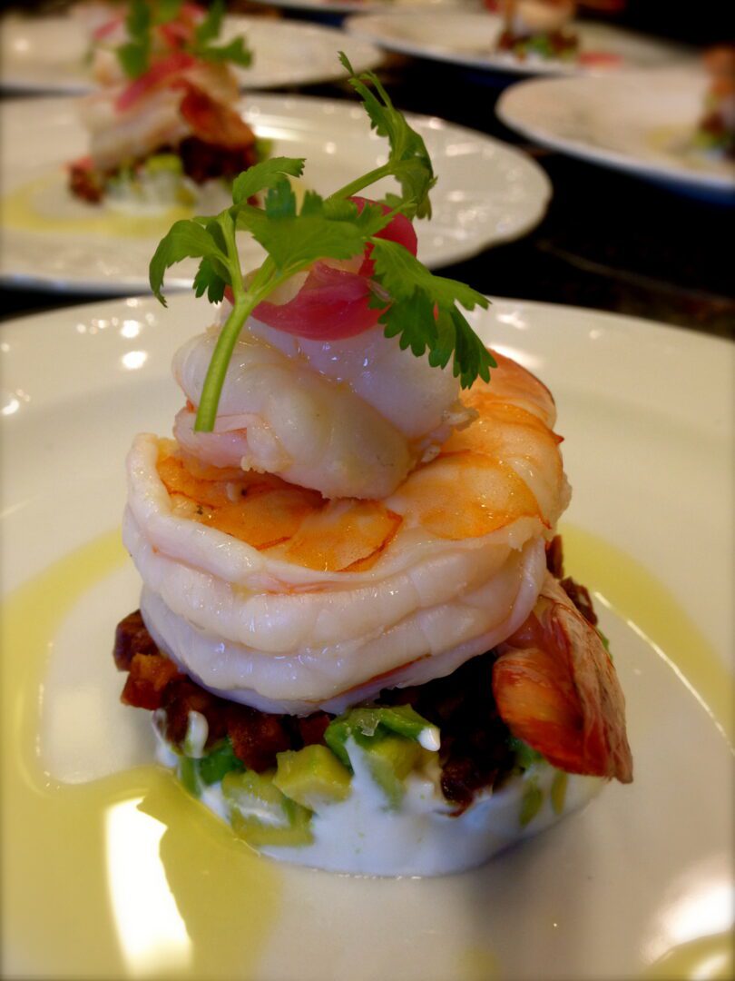 A plate topped with shrimp and arugula.