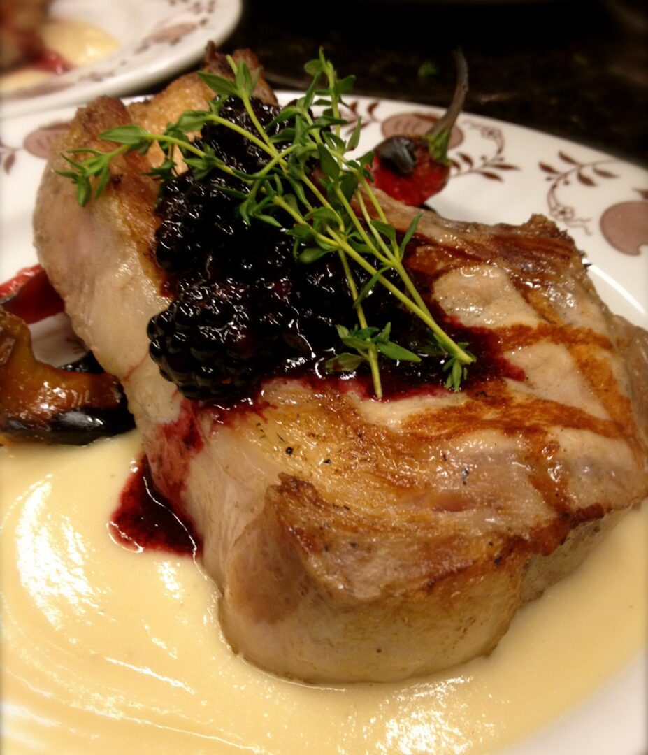 A plate with pork chops on it.