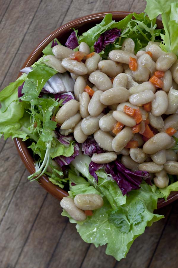White bean salad on a wooden table.