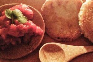 A plate with bread and tomato sauce on it.