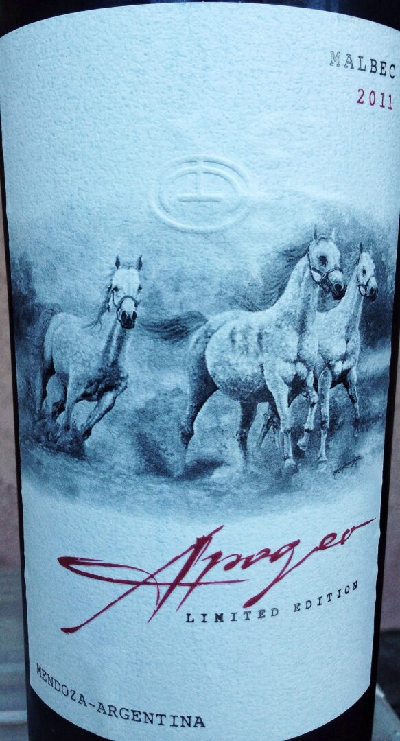A bottle of wine with horses on it.
