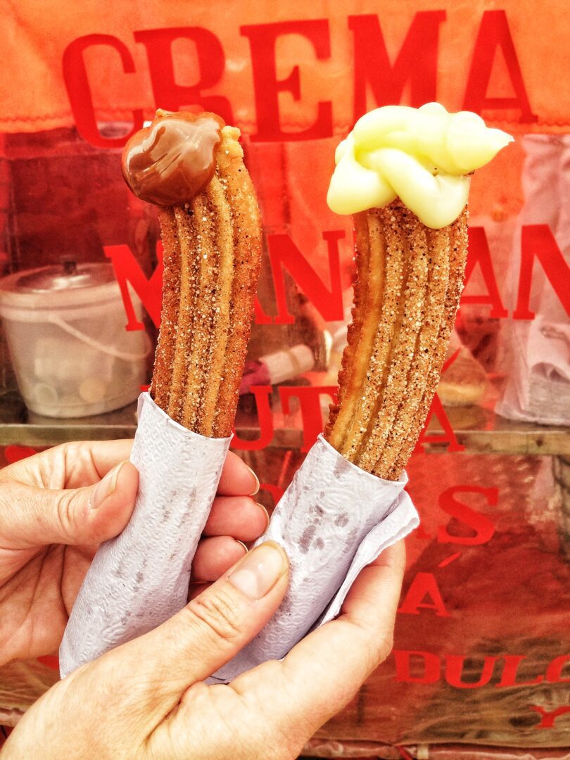 A person holding a churro.