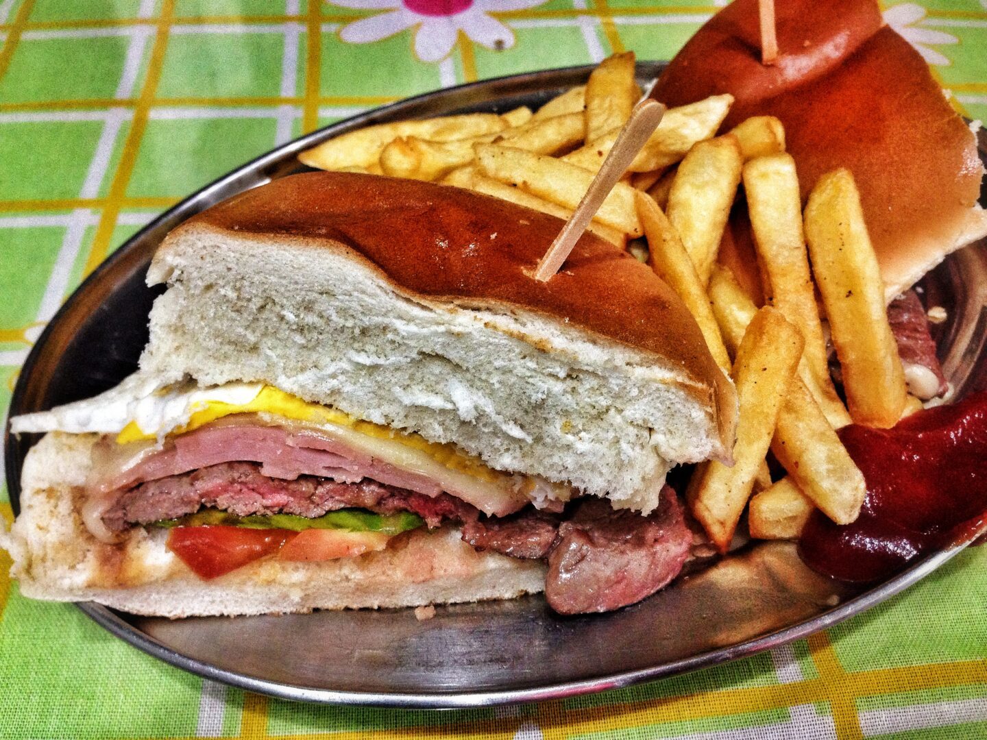 A plate of french fries and a sandwich.