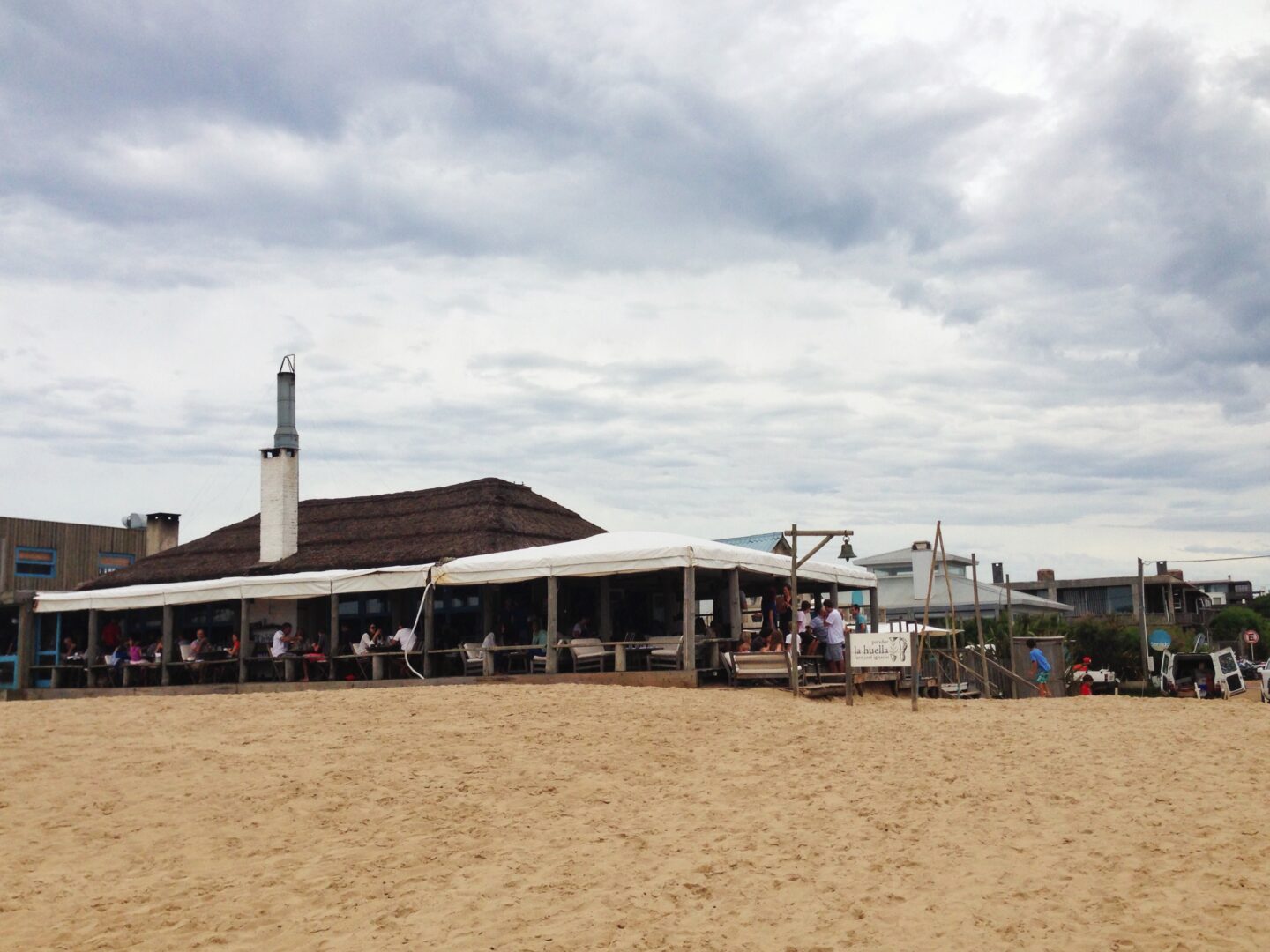 A sandy beach with a building on it.