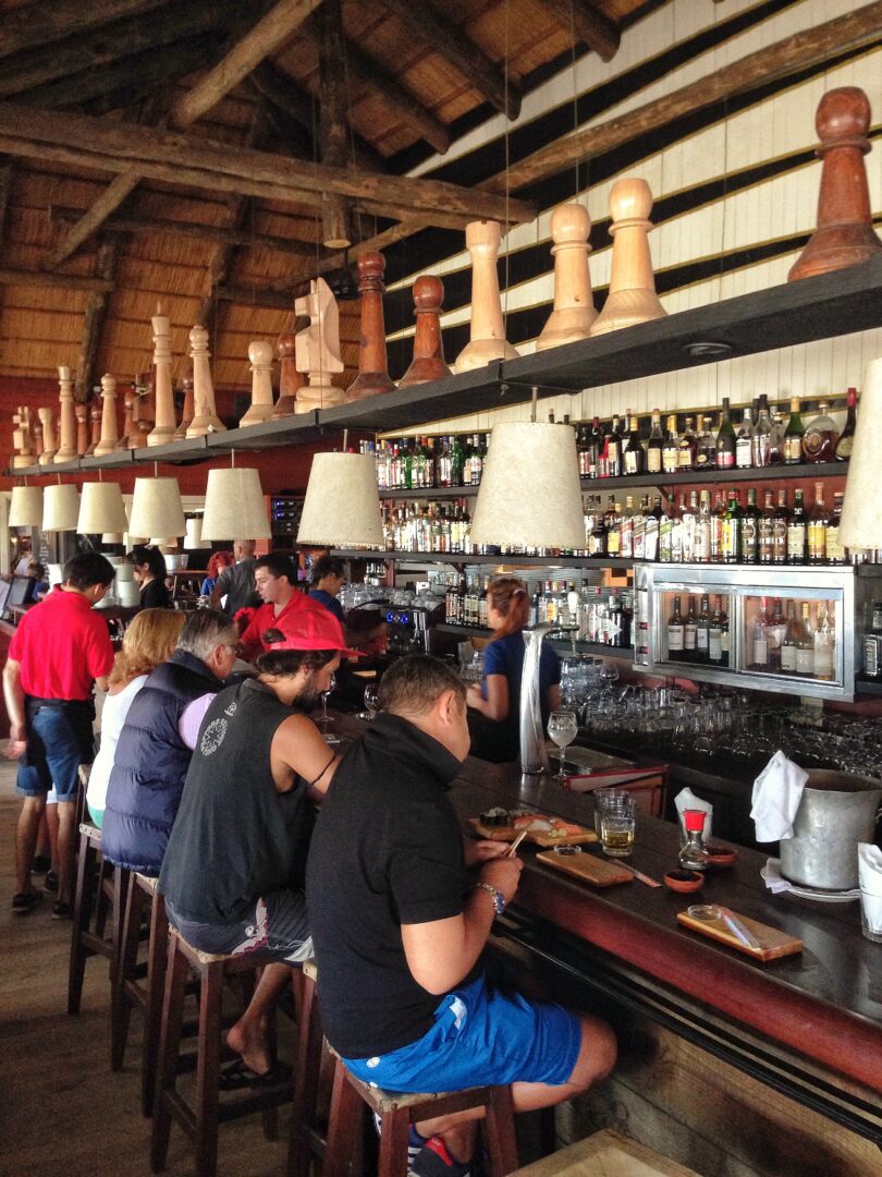 A group of people sitting at a bar.
