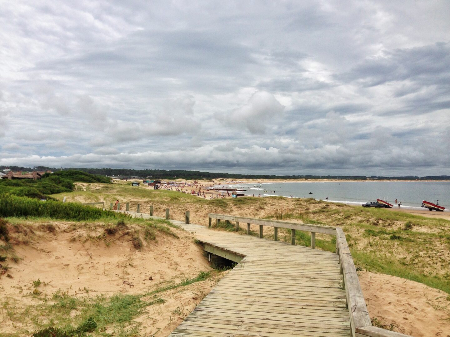 A wooden walkway leading to the beach.