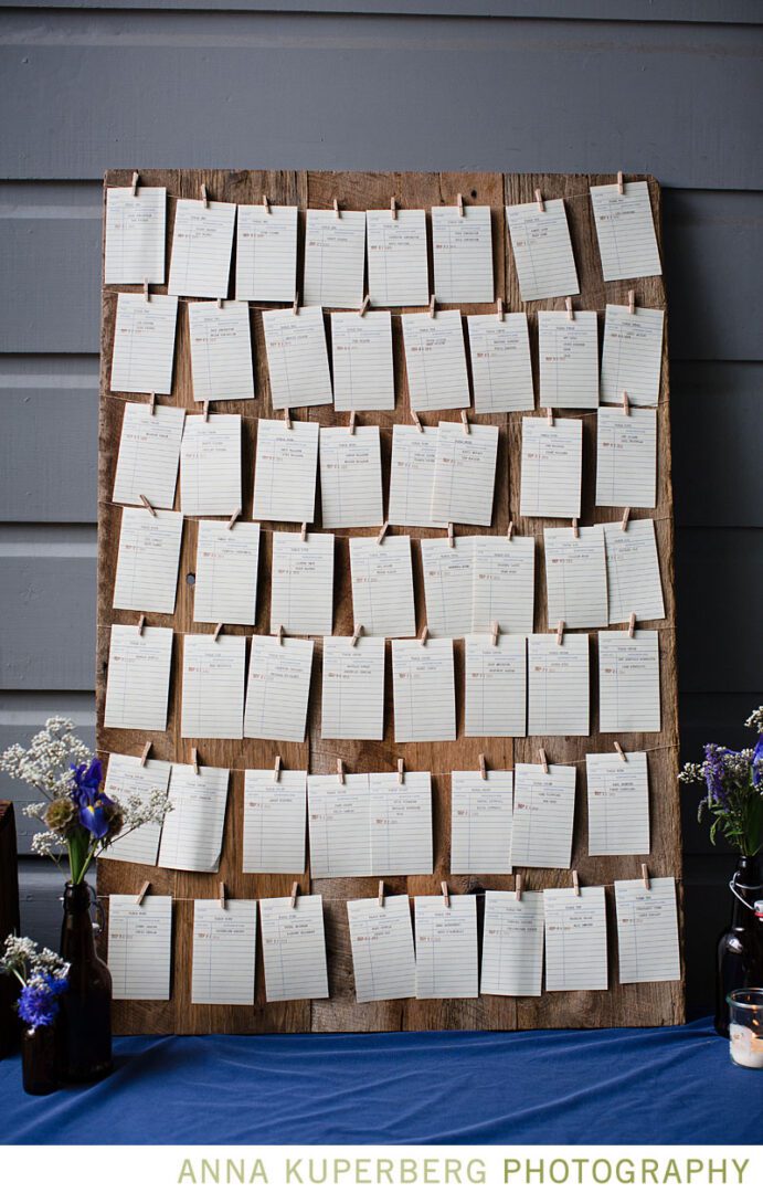 A wooden board with place cards on it.