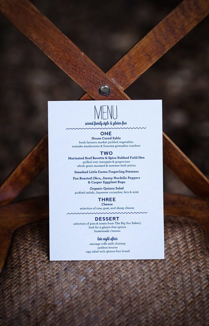 A wooden chair with a menu on it.