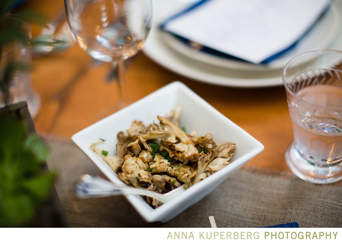 A white bowl of mushrooms on a table.