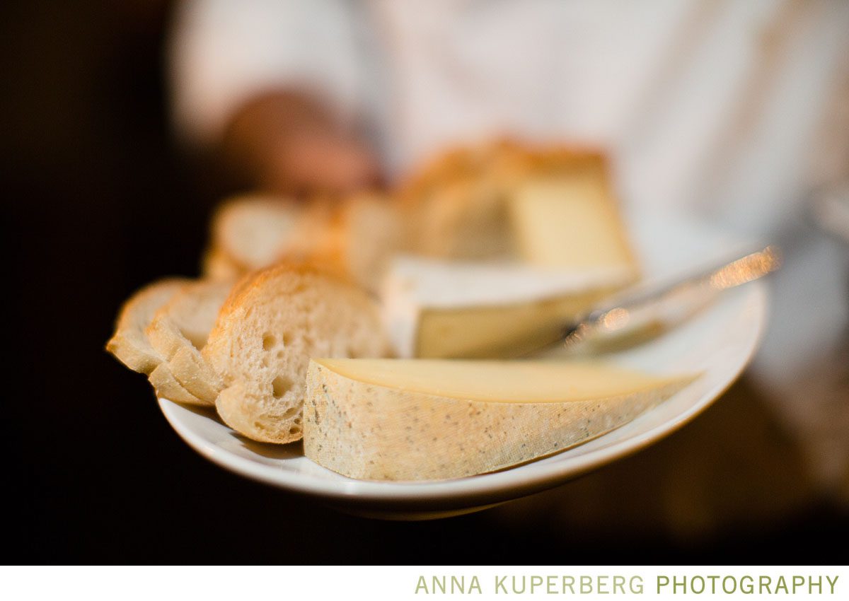 A person is holding a plate of bread and cheese.