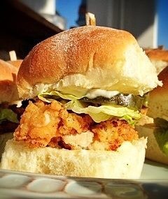 Fried chicken sliders on a plate.