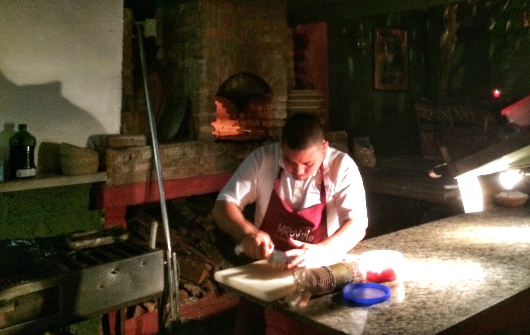 A man is preparing food in a kitchen.