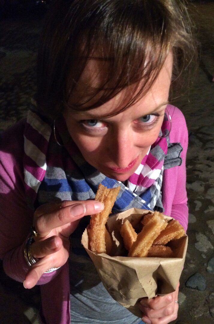 A woman holding a bag of french fries.