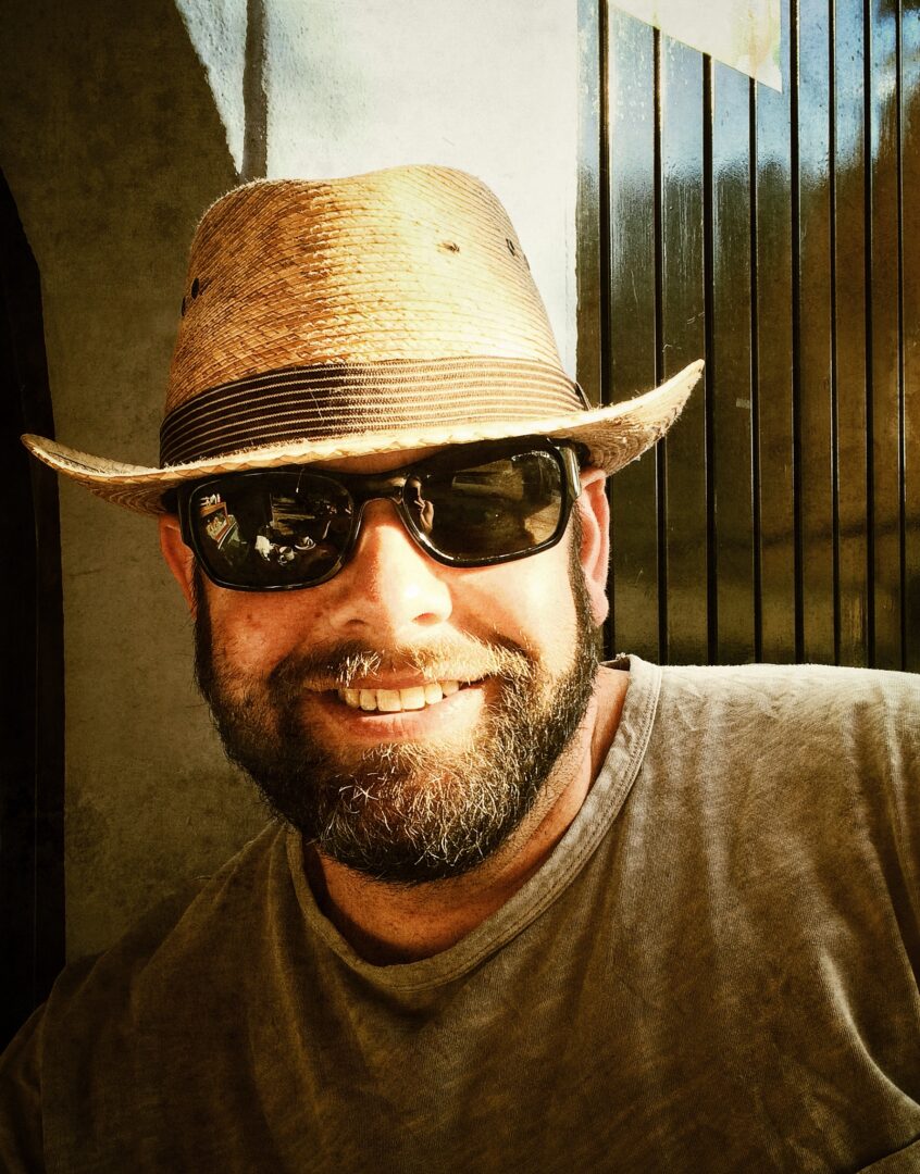 A man wearing sunglasses and a hat.