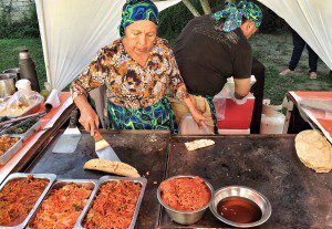 A woman is preparing food in a tent.