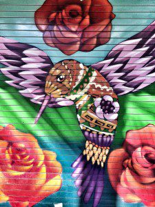 A hummingbird painted on a wall.