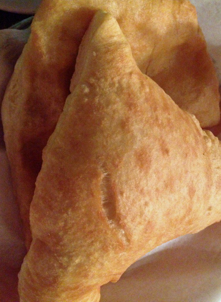 A triangle shaped pastry on a plate.