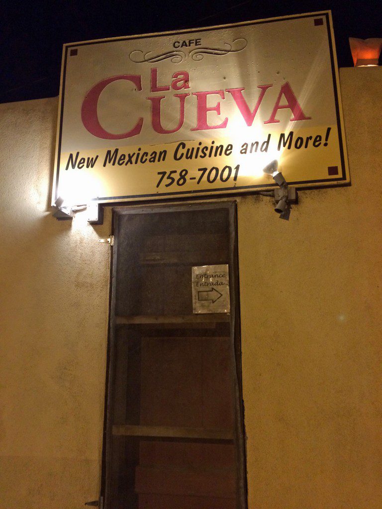 A sign for la cueva new mexican cuisine and motel.