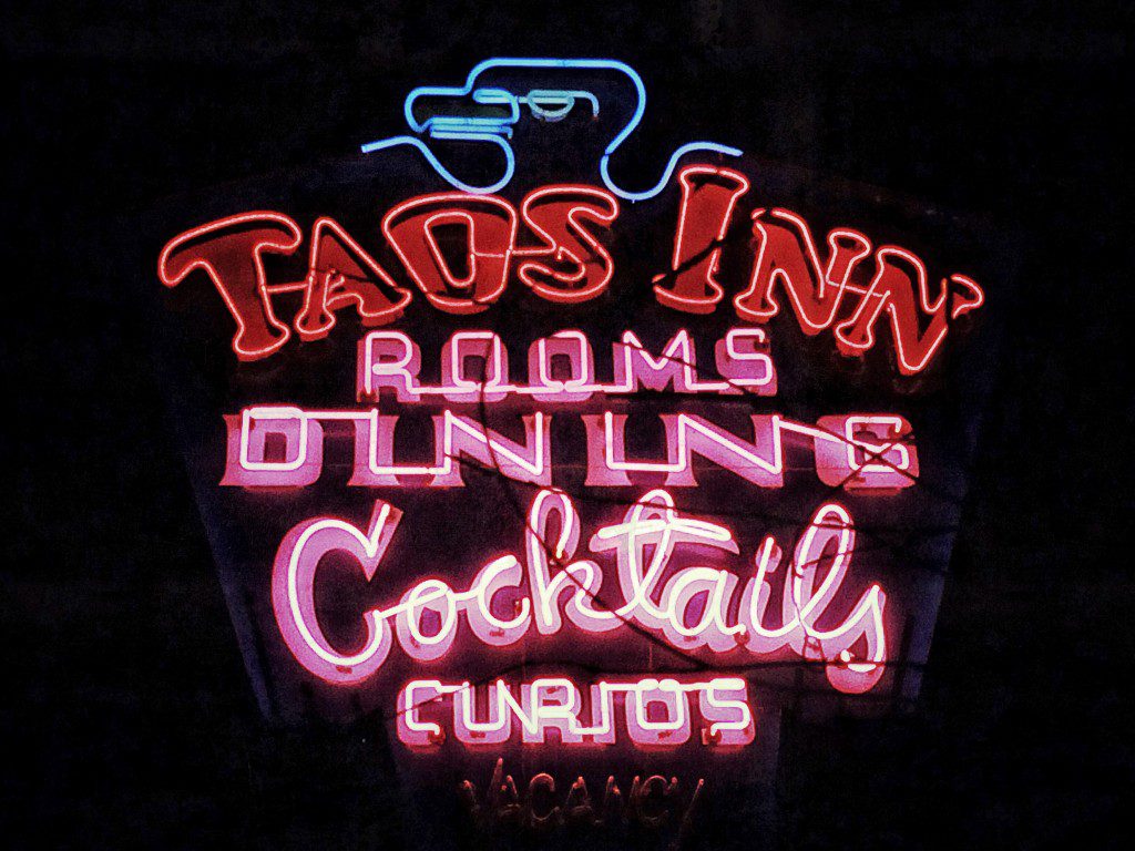 A neon sign that says tad's inn.