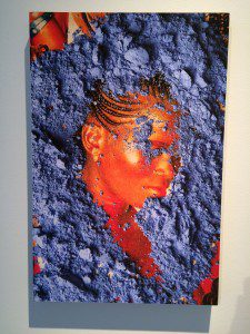 A painting of a woman covered in blue powder.