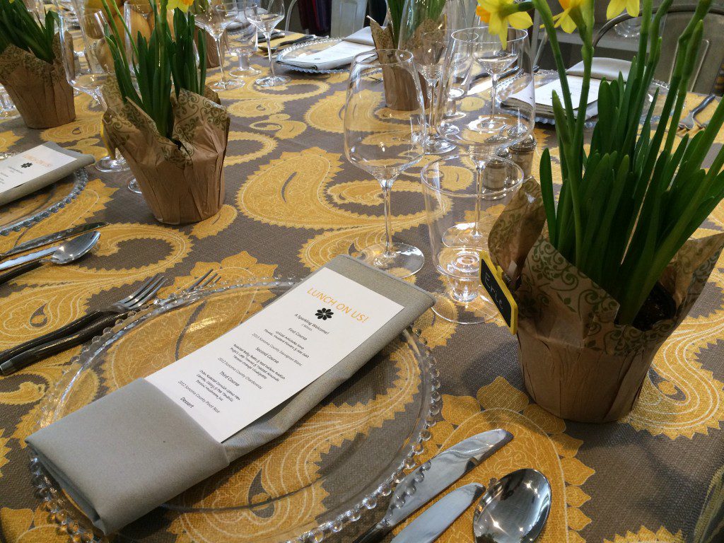 A table set with flowers and a napkin.